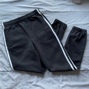 Black joggers with white stripes.